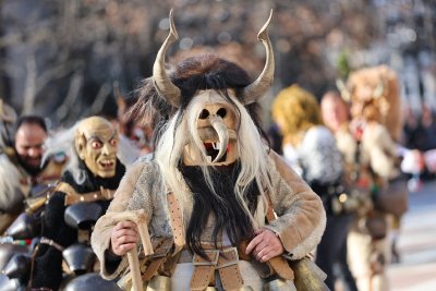 Hundreds of mummers kukeri in traditional and colourful costumes paraded